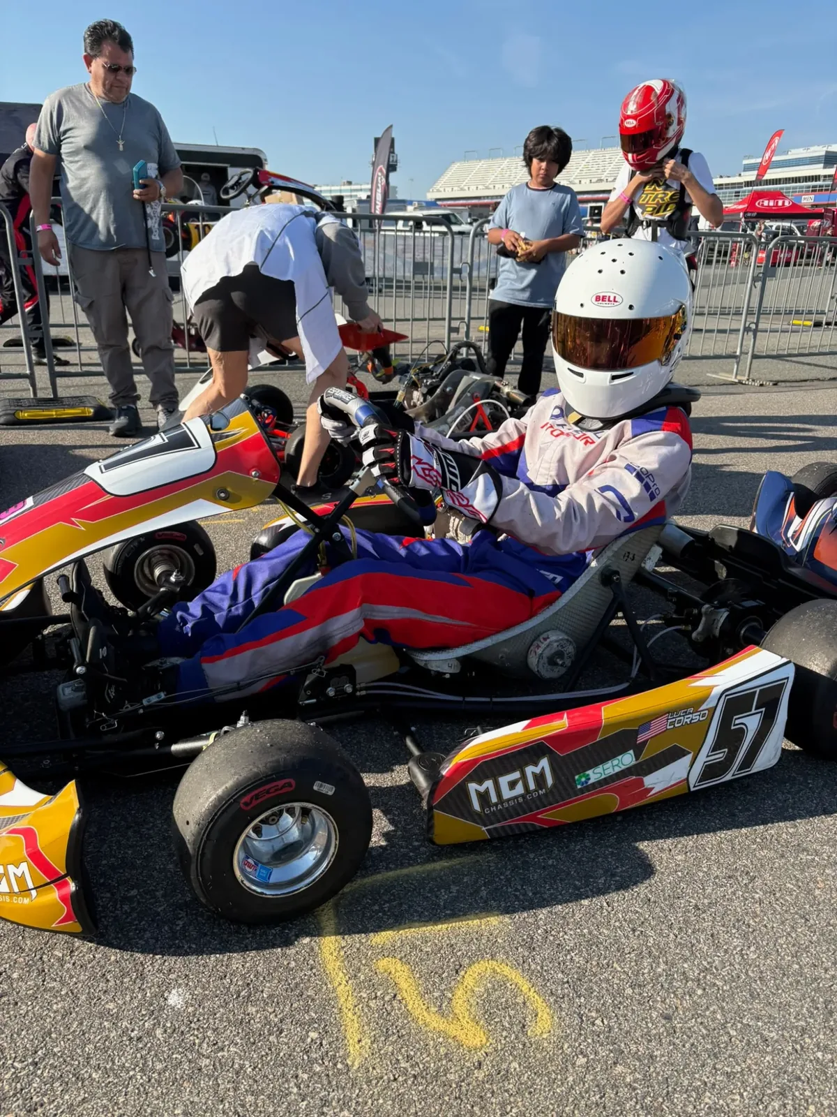 Luca Corso seated in the #57 kart on the grid